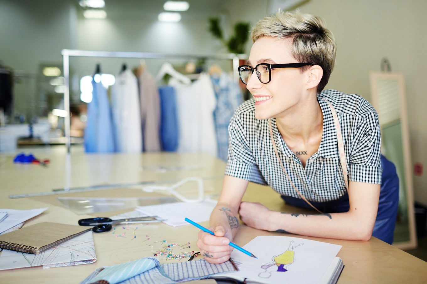 Happy self-employed designer of clothes drawing model of trendy